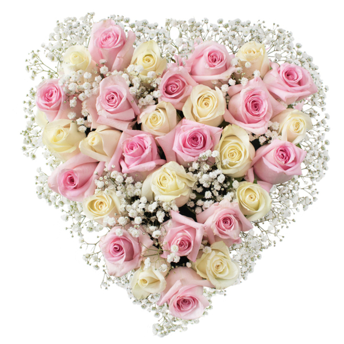 Dominating the frame with timeless elegance, this heart-shaped floral composition weaves together approximately thirty softly blushed pink and creamy white roses, brought to full bloom under the expert hands of Mill Hill's local florists. The petals, with their sensual folds and velvet sheen, create a sense of depth and warmth, set off by the ethereal brilliance of baby's breath-tiny clouds of white that thread through and around the heart, enhancing each rose's beauty while imparting an airy lightness. The warm undertones in the cream roses, verging on pale yellow, and the tender blushes of pink harmonise perfectly, evoking a lingering sense of sunlight filtering through the trees along Mill Hill's green lanes. Evenly lit and displayed against a pristine backdrop, the bouquet emphasizes freshness, artistry, and heartfelt intention-a fitting choice for meaningful tributes, romantic gestures, or moments of remembrance. This visual celebration reflects both the gentle rhythms of local life and the universal language of love, perfectly suited for gifting or memorial occasions throughout the community. Every detail attests to skilled craftsmanship and genuine care, making this arrangement a true work of floral art.