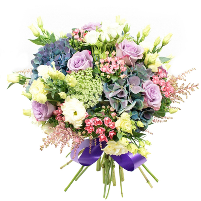 Radiating a symphony of hues, this luxury bouquet captures the refined charm of Mill Hill and its tranquil surroundings. At the centre, generous clouds of indigo, teal, and purple hydrangeas set a lush, textured tone, reminiscent of vibrant displays seen near Mill Hill Broadway and local floral markets. Scattered among these are gracefully spiralled roses in soft lavender and creamy white, their petals opening in flawless, concentric waves. Nestled between them, crisp white ranunculus add billowy volume and subtle sophistication. Slender, lemon-tinged lisianthus buds extend gracefully upward, echoing the gentle rise of Mill Hill's green spaces, while open eustoma blooms introduce fresh, barely-there yellow-green highlights. Playful sprays of fuchsia-pink filler flowers dart among the larger blossoms, creating energetic contrast, while clouds of feathery pale pink astilbe bring in a delicate sense of movement and whimsy reminiscent of quietly blooming hedgerows. Lacy green and white fillers-most likely Ammi Majus-infuse lightness and breezy intricacy into the bouquet, offset by the lush dark green foliage anchoring the design. The gathered stems are meticulously tied with a wide, lustrous royal purple satin ribbon, bringing cohesion and a touch of opulent polish. Perfect as an elegant centrepiece, romantic gesture, or thoughtful gift, this arrangement echoes Mill Hill's unique blend of natural beauty and refined artistry, delivering freshness and joy to homes across NW7.