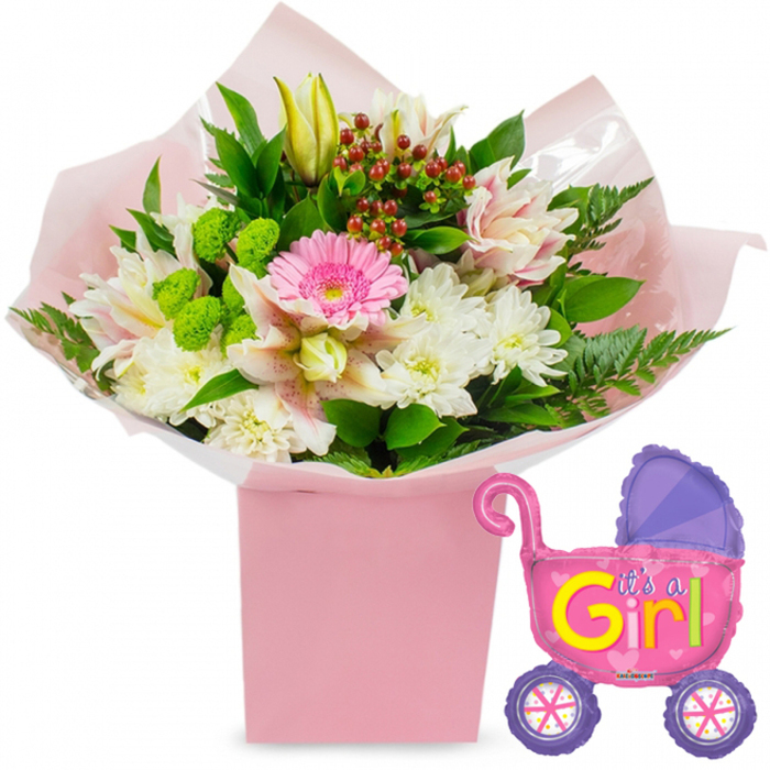 On a spotless white background, a new baby girl floral gift and balloon are presented with simple elegance, every detail clearly visible. At the heart of the scene sits a tall, square light-pink gift box, holding a lush bouquet that seems to burst upwards with colour and texture. The stems are nestled in soft pink tissue paper and wrapped in clear cellophane that forms gentle, translucent folds around the blooms. The central flower is a bright soft-pink gerbera daisy, its tidy ring of petals radiating from a darker centre, creating a strong point of focus. Surrounding this are generous clusters of pure white chrysanthemums, each head made up of countless fine petals that give the bouquet a cosy, full look. Delicate alstroemeria lilies in shades of white and pale blush weave through the arrangement, their slender petals marked with subtle speckles for added interest. Near the top, a closed creamy yellow lily bud extends above the other flowers, suggesting beauty that will unfold gradually, much like the early days with a new baby. Contrasting with the gentle pastels, bright lime-green button-style flowers dot the design, offering rounded bursts of colour and texture. Here and there, deep red hypericum berries are tucked among rich green foliage: broad, glossy leaves and soft fern fronds that expand the bouquet's shape beyond the edges of the box. Just to the right, a foil balloon shaped like a traditional baby pram floats slightly apart from the flowers. The balloon gleams in hot pink, with a darker purple hood and rounded purple wheels decorated with multi-coloured spokes, bringing a fun, almost toy-like charm. Bold yellow and green lettering along the side clearly reads It's a Girl!, framed by scattered pink hearts. The scene could easily belong to a Mill Hill living room flooded with afternoon light, a gift ordered from Flowers Mill Hill for same-day delivery around Mill Hill Broadway to celebrate a newborn daughter.