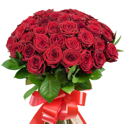 The picture features a majestic bouquet, brimming with the classic elegance of deep red roses, their velvety petals unfolding in soft spirals from tight buds to luscious full blooms. The arrangement forms an impressive, rounded shape, the abundance of crimson inviting both admiration and a tactile longing, reminiscent of the vibrant spirit found in Mill Hill Broadway cafés and parks. Glossy green leaves, richly veined and robust, peek out from between the blooms, introducing a lively contrast and echoing the area's abundant foliage. The sturdy stems are skillfully gathered and encircled at the base with a wide red satin ribbon, expertly tied into an elaborate, cascading bow that glimmers softly under gentle light. There's an undeniable sense of celebration in every detail-the careful composition, dynamic interplay of tones, and luxurious finishes evoke the joy of life's grand gestures. Whether presented as a declaration of profound affection, a heartfelt anniversary offering, or a show-stopping Valentine's Day gift, this bouquet radiates intention and artistry, crafted with the care and authenticity you'd expect from Mill Hill's premier local florists.