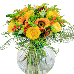 This Mill Hill-inspired bouquet exudes the brightness of a late summer afternoon, thoughtfully curated by local florists who cherish the greenery of North London. The sunflowers dominate, their rich brown centers and flamboyant yellow-orange petals beaming outward like small suns over the fields near Copthall. Swirling around them, yellow garden roses spiral open with velvety softness, inviting the gentle touch and subtle perfume that speaks of classic luxury. Glossy red hypericum berries dot the ensemble with cheerful, gem-like highlights, evoking the playful buzz of flower stalls on Mill Hill Broadway. Cascading fern fronds, brimming with airy texture, lend flow and dimension to the bouquet's edge, their movement reminiscent of the gentle breeze down Lawrence Street. Delicate sprays of solidago scatter clusters of tiny yellow blossoms, mingling with slender green spikes and the cool sage hue of eucalyptus to add a rustic, natural flourish. The rounded, clear glass vase showcases vibrant stems in crystal water, revealing the structure and artistry behind every detail. Imagine the soft rustle of leaves, the fragrance of roses, and the sense of renewal that flowers bring-this radiant arrangement is perfect to celebrate special occasions or simply bring cheer to a Mill Hill residence. Each hand-placed element is a tribute to local craftsmanship, available for same-day delivery throughout NW7.
