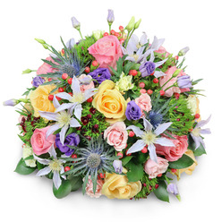 This photograph presents a meticulously crafted domed bouquet, isolated against a bright white background so every flower can be appreciated in detail, as if you were standing in a light-filled Mill Hill kitchen admiring fresh delivery on the table. The arrangement is rounded and full, with each stem placed to create a seamless canopy of blooms. Dominating the design are lush garden roses in gentle pastel shades: blush pink, mellow yellow, and creamy peach. Their petals are densely layered and softly curled, some roses completely open to reveal their romantic hearts, others still unfolding. Woven between them are airy clematis flowers, each one a starburst of narrow petals tinted white to pale lavender, with striking yellow or creamy centers that catch the eye like tiny suns. For contrast, several stems of blue eryngium, or sea holly, rise slightly above the softer forms, their spiky, metallic blue-grey heads and serrated bracts lending a cool, architectural presence that evokes wild flowerheads seen along country walks outside Mill Hill. Tucked into the gaps are clusters of purple lisianthus, including tightly furled buds and partially open blooms, adding depth of colour and soft, velvety texture. Scattered throughout, bright red hypericum berries form compact clusters of smooth, round beads, bringing bursts of vibrant colour and a firm, glossy texture under the fingers. Enclosing the bouquet is a rich mix of green foliage: broad, shiny leaves that anchor the design, delicate feathery greenery that softens the overall shape, and touches of deeper, burgundy-tinged leaves for subtle drama. The even lighting gently emphasizes the bouquet's contours and intricate textures, creating an impression of freshness and quiet celebration, suitable for birthdays, anniversaries, or simple acts of kindness sent to homes and offices around Mill Hill.