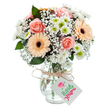 Effortlessly capturing the sense of peace found in Mill Hill's leafy neighbourhoods, this lush floral bouquet features fully opened peach-pink roses and two radiant peach gerbera daisies with distinct, chocolate-brown centres, arranged to highlight both elegance and cheer. White chrysanthemums with brilliant green centres contribute texture and brightness, while buoyant sprigs of baby's breath add a misty, weightless quality. Scattered eucalyptus leaves provide fresh scent and structure, reminding you of woodland strolls along Arrandene Open Space. The entire arrangement, crafted by a Mill Hill florist passionate about detail, is displayed in a clear, lightly textured glass vase, with visible green stems set in sparkling water. Around the vase neck, rustic natural twine is tied neatly, anchoring a white rectangular tag ready for celebration wishes or personal greetings. This bouquet's harmonious colour palette and thoughtful construction create a serene, affectionate presence-perfect for commemorating special occasions, sharing gratitude, or brightening homes throughout Mill Hill and beyond.