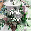 From the sunlit edge of Mill Hill this stunning Florist Choice bouquet sits as if catching the last glow of a spring afternoon. The arrangement speaks of premium, bespoke design, anchored by a soft white overlay at its center bearing Florist CHOICE and the price ?200 in elegant, understated type. The palette sits in soft pastels and muted tones, a refined harmony that feels crafted for a special celebration rather than a routine gesture.

At the heart are fully open light pink garden roses, paired with creamy white anemones whose centers are a dramatic, nearly black dot of color, and subtly lavender grey roses that lend modern depth. A touch of spiky blue eryngium thistles introduces a cool accent and architectural texture. Lush foliage surrounds the blooms - slender eucalyptus like leaves and darker burgundy leaves - giving the bouquet body, movement, and a natural, garden fresh feel.

Overall the arrangement reads as substantial and high value, the kind of piece a skilled designer would curate for a wedding, anniversary, or meaningful gift. The background is gently blurred, implying an outdoor setting with soft natural light that lets every petal and vein on a leaf glow. For Mill Hill deliveries and nearby NW7 postcodes, this Florist Choice would be a trusted, designer led choice ready to brighten a room or a celebration with quiet elegance. The bouquet carries a delicate rose scent and a hint of crisp greenery, inviting touch and lingering memory.