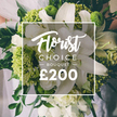 Rendered in white and lime green, this Florist Choice Bouquet is a striking fusion of purity and modern energy. The large white lilies command attention with expansive, velvety petals, while clusters of bright chartreuse greens add buoyant texture and volume, echoing the sparkle of hydrangea heads or Green Trick dianthus. Smaller white blossoms-ranunculus or spray roses-are tucked among the stems, their soft forms lending tactful rhythm to the composition, and dark green foliage threads through to anchor the design. The bouquet appears hand tied, the stems gathered with care, and a hint of a pale wedding gown is visible in the softly blurred background, making the moment feel intimate and celebratory. A white framed overlay sits at the center of the image, bearing the brand with Florist Choice Bouquet in flowing script and the price shown boldly at the bottom, signaling a premium gift from Flowers Mill Hill.

From Flowers Mill Hill, this arrangement is framed as a luxury gift with practical appeal: available for same-day or next-day delivery across Mill Hill, Church End, Finchley, and neighboring streets, bringing high-end floristry to life for weddings, anniversaries, or meaningful milestones. The bouquet's white and lime palette offers versatility for ceremonies or elegant congratulatory moments, while the design's clean lines and lush greenery speak to the florist's artistry and commitment to freshness.