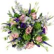 This overhead photograph captures a hand-crafted bouquet arranged in a full, rounded shape, its palette of dusty pink, lavender, deep violet, and vivid green glowing gently against a pure white surface, as if presented on a bright countertop in a Mill Hill home. Central to the design are large, open roses in soft blush and muted mauve, with petals that curl outward in smooth spirals, creating plush, layered rosettes that feel both romantic and timeless. Nestled lightly between them are clusters of delicate, daisy-like asters in pale lavender tones, each flower crowned by a small yellow centre that brings a hint of sunshine and enhances the bouquet's airy feel. Deeper hues are introduced by lisianthus blooms in saturated purple and indigo shades, their gently ruffled, bell-shaped petals adding shadows and richness that draw the eye inward. From this base of rounded forms, slender purple Veronica spikes spring upward, their columns of tiny florets adding movement and a whisper of wildflower meadow, reminiscent of the natural greenery around Mill Hill's open spaces. Scattered throughout, bright chartreuse-green globes of Green Trick Dianthus provide striking textural contrast, their fine, moss-like surfaces breaking up the smoother petals with playful, sculptural energy. Soft, silvery eucalyptus leaves frame and weave through the bouquet, arching outward to soften the edges and suggesting a cool, refreshing scent that mixes with the gentle sweetness of the roses. Additional foliage and emerging buds tuck into the spaces, creating layered depth and an impression of fresh abundance. The overall mood is one of modern elegance with a relaxed, garden-inspired touch, an arrangement well suited for birthdays, quiet celebrations, or a thoughtful delivery to friends and family across Mill Hill and the surrounding neighbourhood.