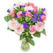 As I place the last stem in this bouquet, I'm reminded of Mill Hill's tranquil gardens and gentle community feel. Soft pink roses unfurl among pale Gerbera daisies, their hues glowing warmly against a backdrop of abundant, shiny greenery-each layer hinting at youthful romance or the hopefulness of new beginnings. Playful bursts of deep violet statice peek through, introducing lively contrast and a subtle, wild fragrance, much like a stroll near the wildflower patches by Mill Hill's Bella Vista. The whole bouquet carries a sense of joyful lightness: airy yet full, as if plucked from a local meadow on a bright spring morning. Presented in a clear glass vase, the stems visible and immersed in fresh water, the arrangement feels authentic and uplifting-suited for a birthday, to send congratulations, or simply to brighten a table along Daws Lane. Every bloom is here for beauty and sentiment, ensuring the gift is not just seen but truly felt, and that whoever receives it experiences the heart of Mill Hill's warmth and floral artistry.